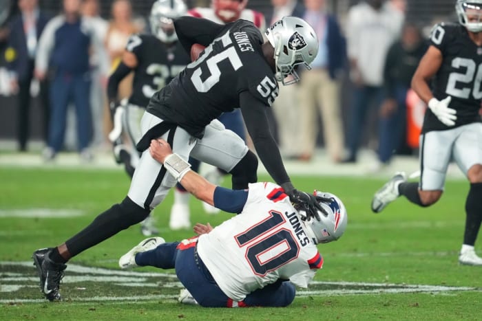 Raiders defensive end Chandler Jones pushes down Patriots quarterback Mac Jones and races to the end zone on the final play of the game for the win.